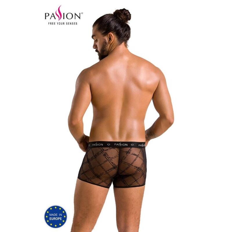 Back view of a muscular man wearing black sheer plaid boxer briefs by Passion, with a 'Made in Europe' badge in the corner.