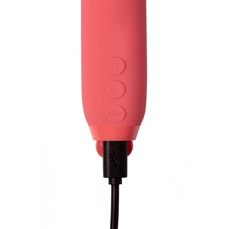 Pink handheld personal massager with plus and minus control buttons and a USB charging plug connected.