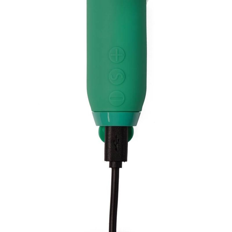 Close-up of a green handheld device end with a USB cable plugged in.