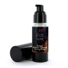 Bottle of Extase Sensuel massage lubricant with pump, chocolate‑orange scent, black label with orange design; cap lying beside the bottle.