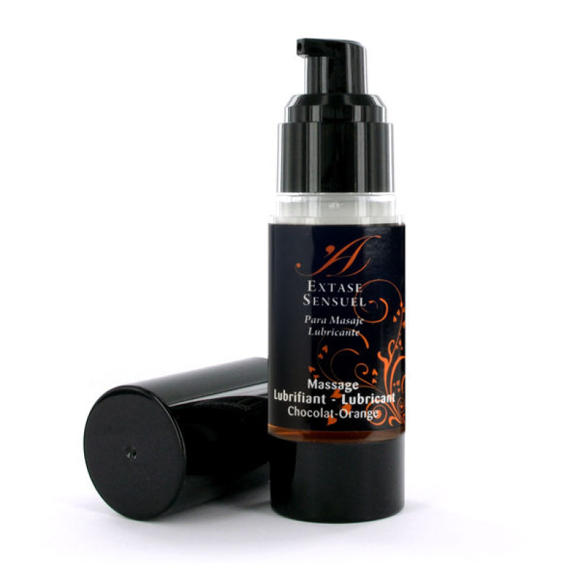 Bottle of Extase Sensuel massage lubricant with pump, chocolate‑orange scent, black label with orange design; cap lying beside the bottle.
