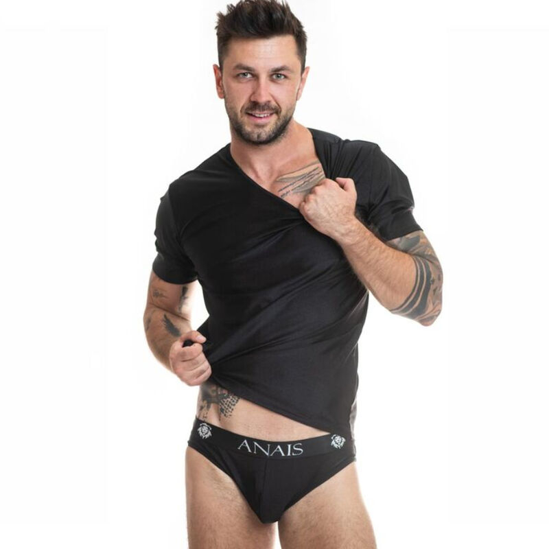 Male model in black ANAIS briefs, lifting his shirt to reveal the waistband and tattooed arms.