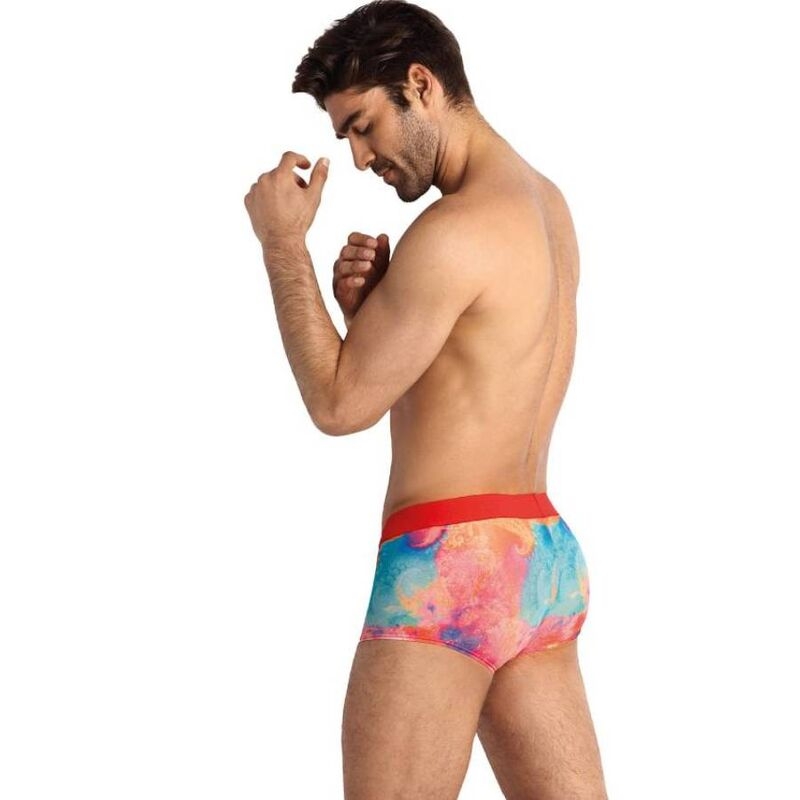 Man standing in profile wearing colorful tie-dye boxer briefs with a red waistband.