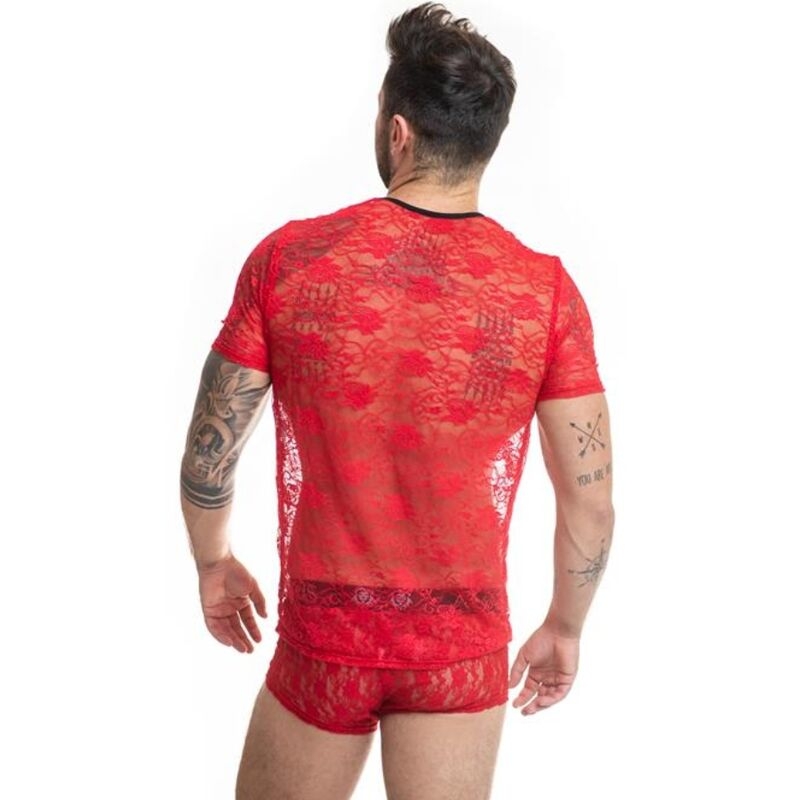Back view of a man wearing a sheer red lace lingerie top and matching briefs, showing tattooed arms against a white background.