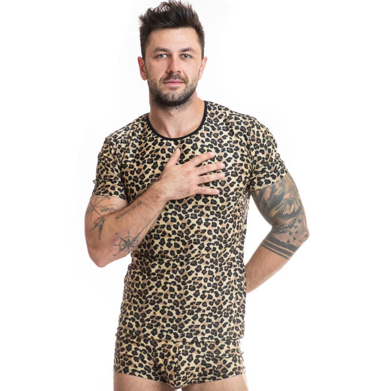 Man in leopard-print matching T-shirt and shorts posing with hand on chest against a white background, tattoos visible on arms.
