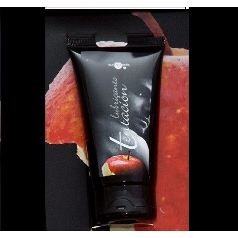 Black squeeze tube with white cursive text and a small red apple image on the front, lying on a dark surface.