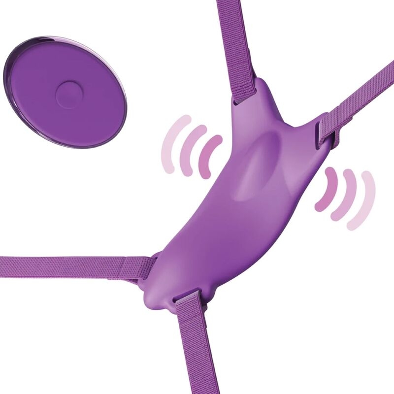 Purple silicone sex toy with four adjustable elastic straps radiating from a central vibrating hub; round remote control disk nearby.