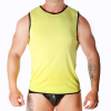 Male model wearing a neon yellow sleeveless top with black trim and black briefs, standing with arms at sides, tattoos visible on arms against a white background.