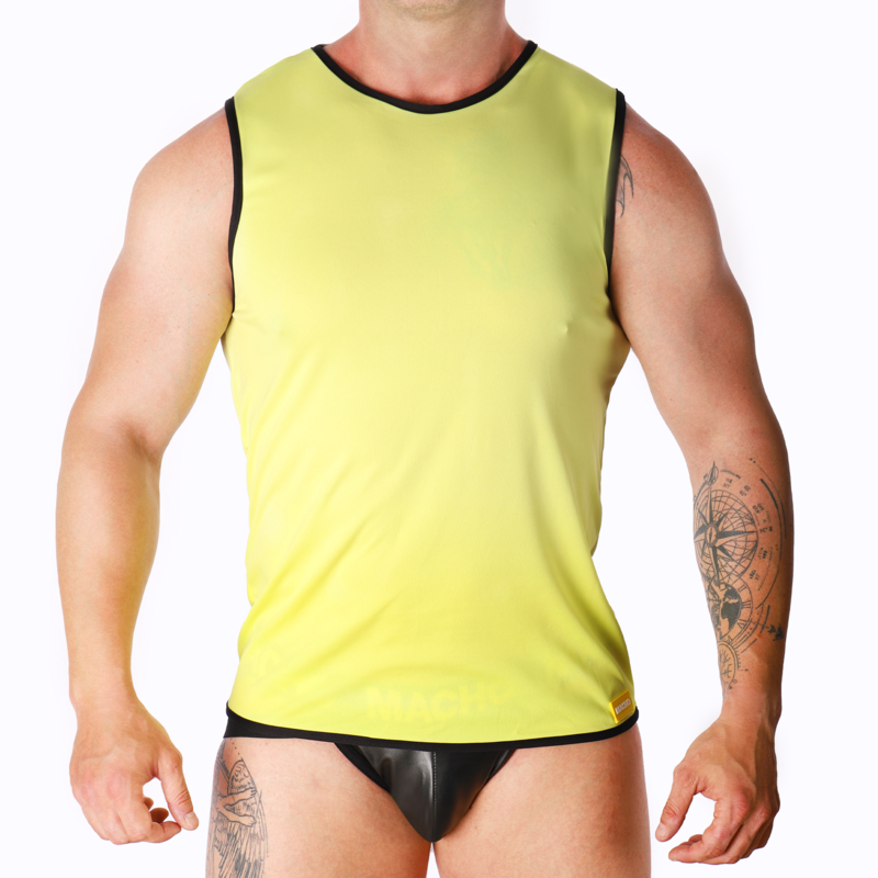 Male model wearing a neon yellow sleeveless top with black trim and black briefs, standing with arms at sides, tattoos visible on arms against a white background.