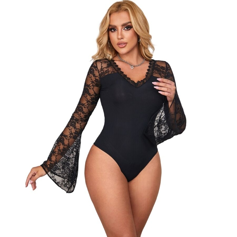 Model wearing a black lace-sleeve bodysuit with sheer lace sleeves and a V-neck.