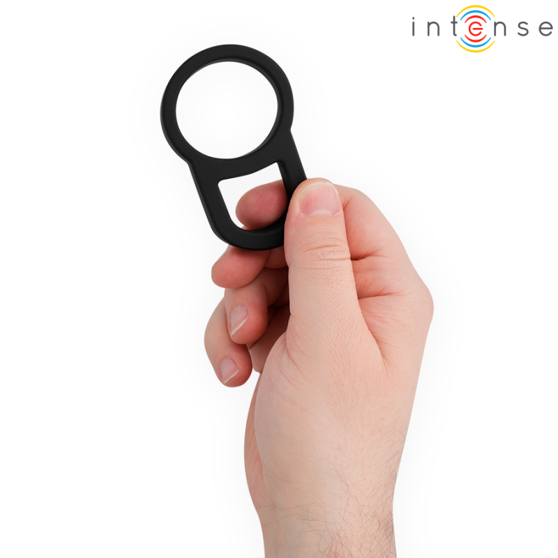 Close-up of a hand gripping a black circular ring with a built-in bottle opener notch, a compact bottle-opening tool.