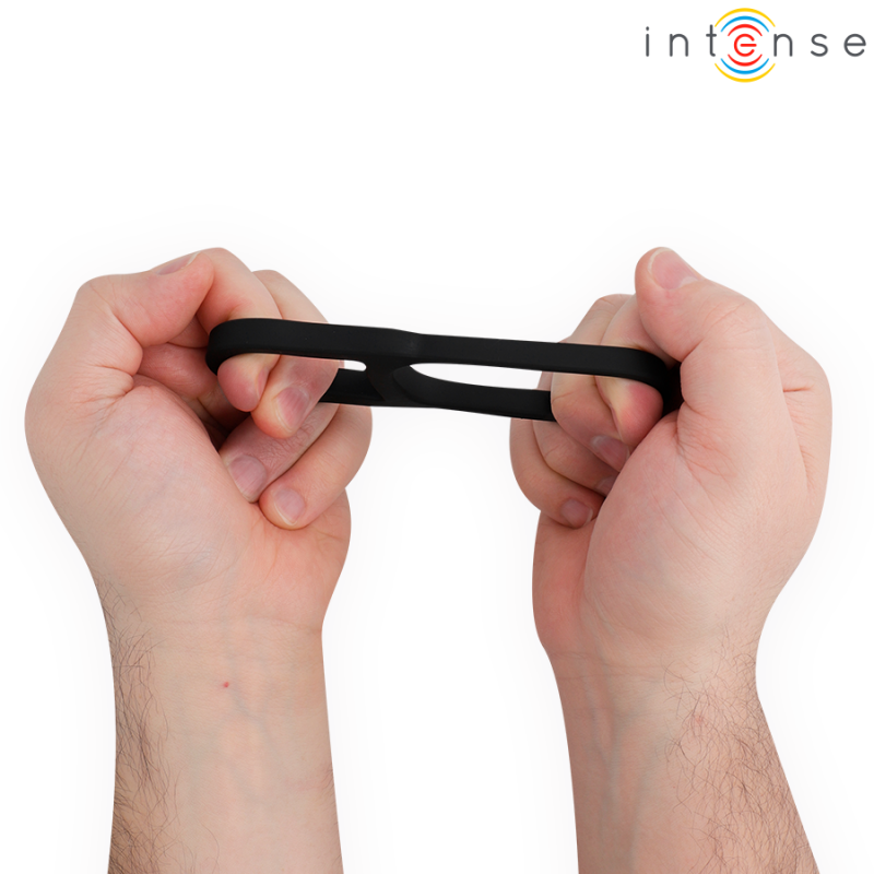 Close-up of hands stretching a black finger-resistance band for grip training