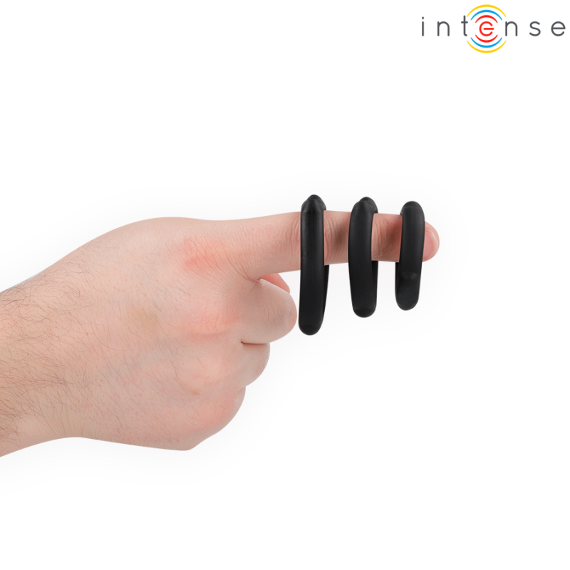 Hand with three black silicone finger rings on the index finger against a white background, showing a playful grip accessory.