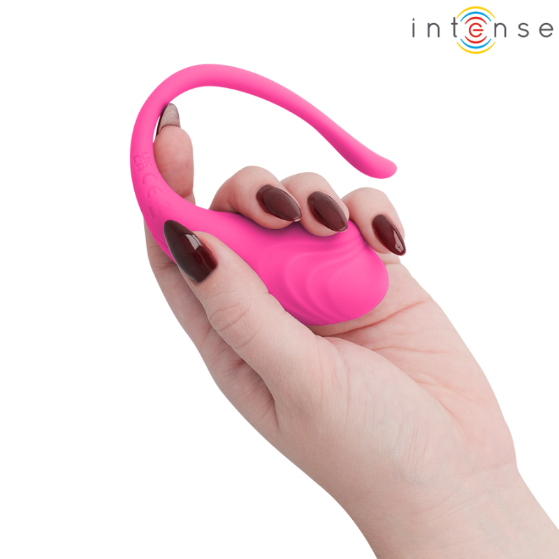 img_221425_69440a1707edf502e1f209bdde2990c3_1png - Sex Shop | Lodia.gr - 100% Διακριτική Και Παράδοση με courier της επιλογή σας Pink silicone vibrator with a curved loop handle, held in a hand with dark nail polish; Intense logo visible in the top-right.