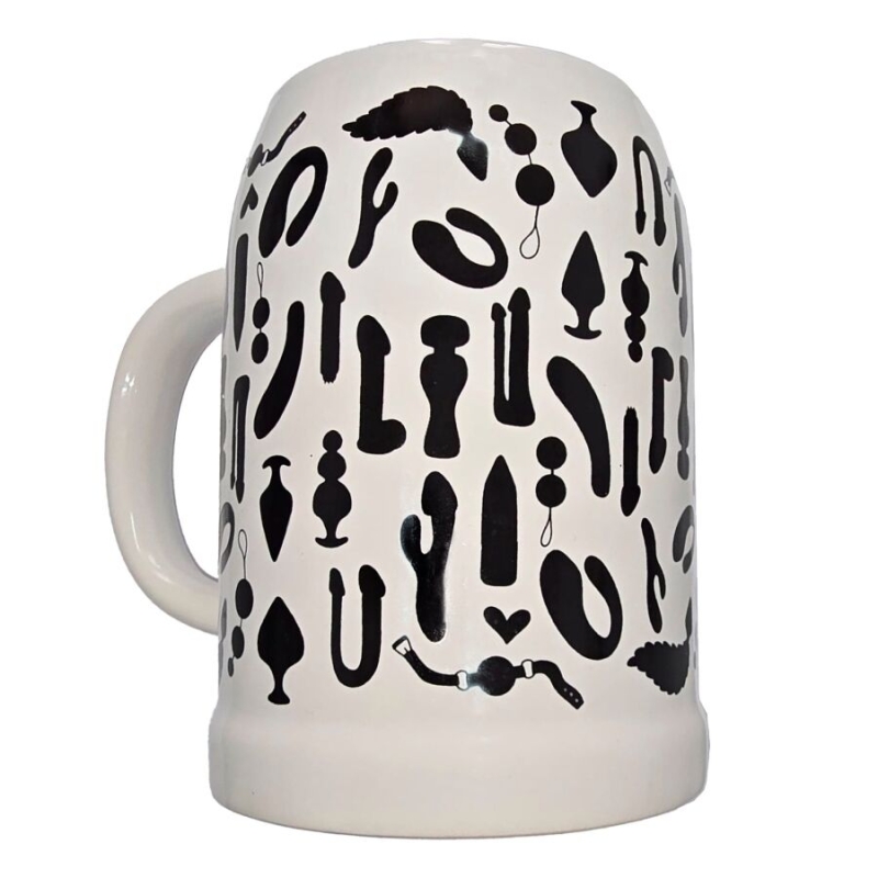 White ceramic beer stein covered in black silhouettes of various sex-toy shapes.