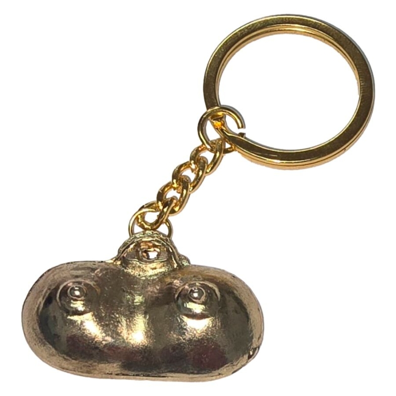 Gold-toned keychain with a rounded charm resembling a chest with two raised bumps (nipples) on a chain and ring.