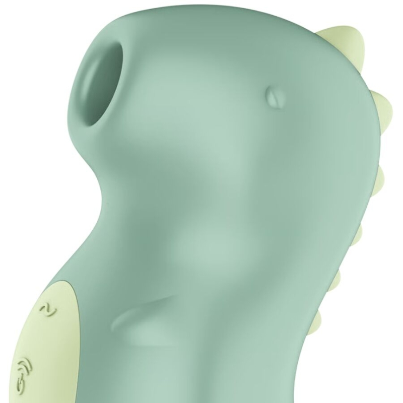 Mint-green silicone handheld massager with small pale-yellow ribs along the back, shown in close-up.