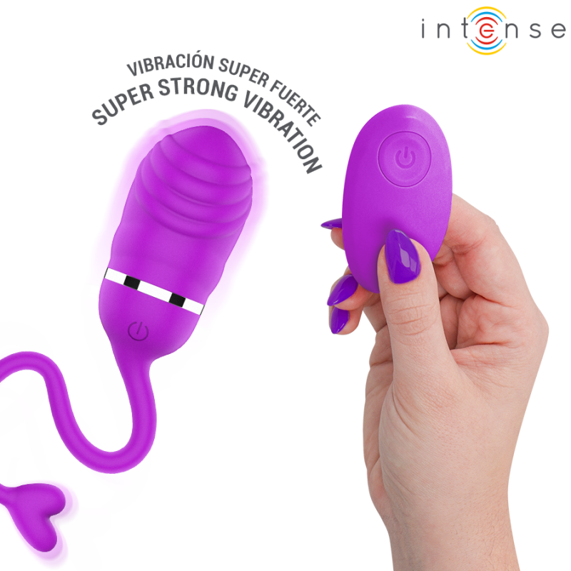 img_223830_1ce9dc8de959c9d038cb65f2e5ea949a_1png - Sex Shop | Lodia.gr - 100% Διακριτική Και Παράδοση με courier της επιλογή σας Purple vibrator with a matching remote being held by a hand with purple nails; curved shaft and tail, advertising text 'SUPER STRONG VIBRATION' above.