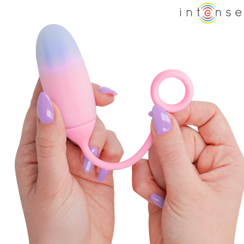 img_223903_bbc84936051fcf428bd9ad660e8bfade_1png - Sex Shop | Lodia.gr - 100% Διακριτική Και Παράδοση με courier της επιλογή σας Hands hold a pink silicone vibrator with a gradient blue tip and a ring at the end; Intense logo top-right.
