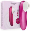Pink Womanizer clitoral stimulator with white tip beside its pink packaging box, product shot for sexual wellness.
