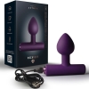 Purple silicone anal plug with a flared base shown beside its dark packaging labeled Rocks Off Nova Astryx and a USB charging cable.