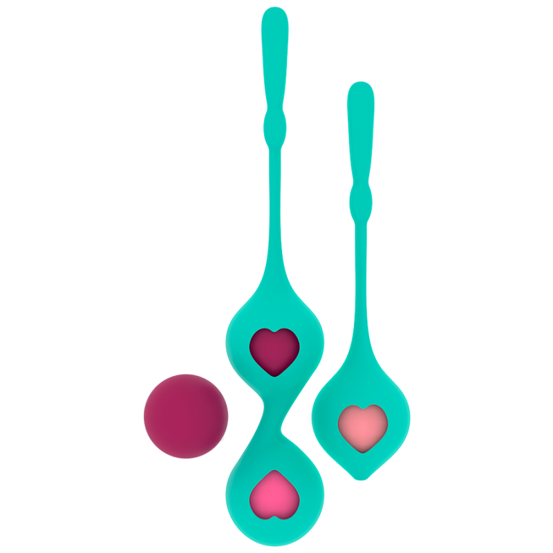 Two turquoise silicone spoons with heart-shaped cutouts showing pink hearts, and a floating pink ball on a white background